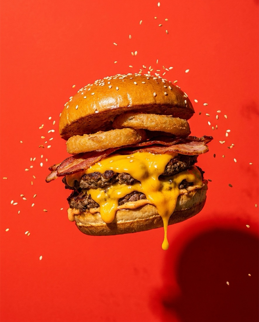 Food campaign visual — gourmet burger on red