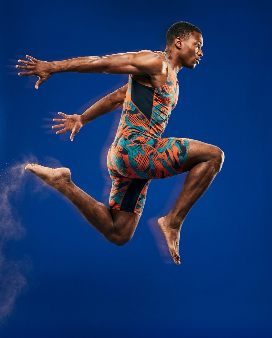 Fitness campaign visual — athlete leaping on cobalt blue